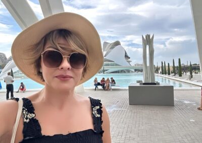 A woman in a sunhat and black dress in Valencia